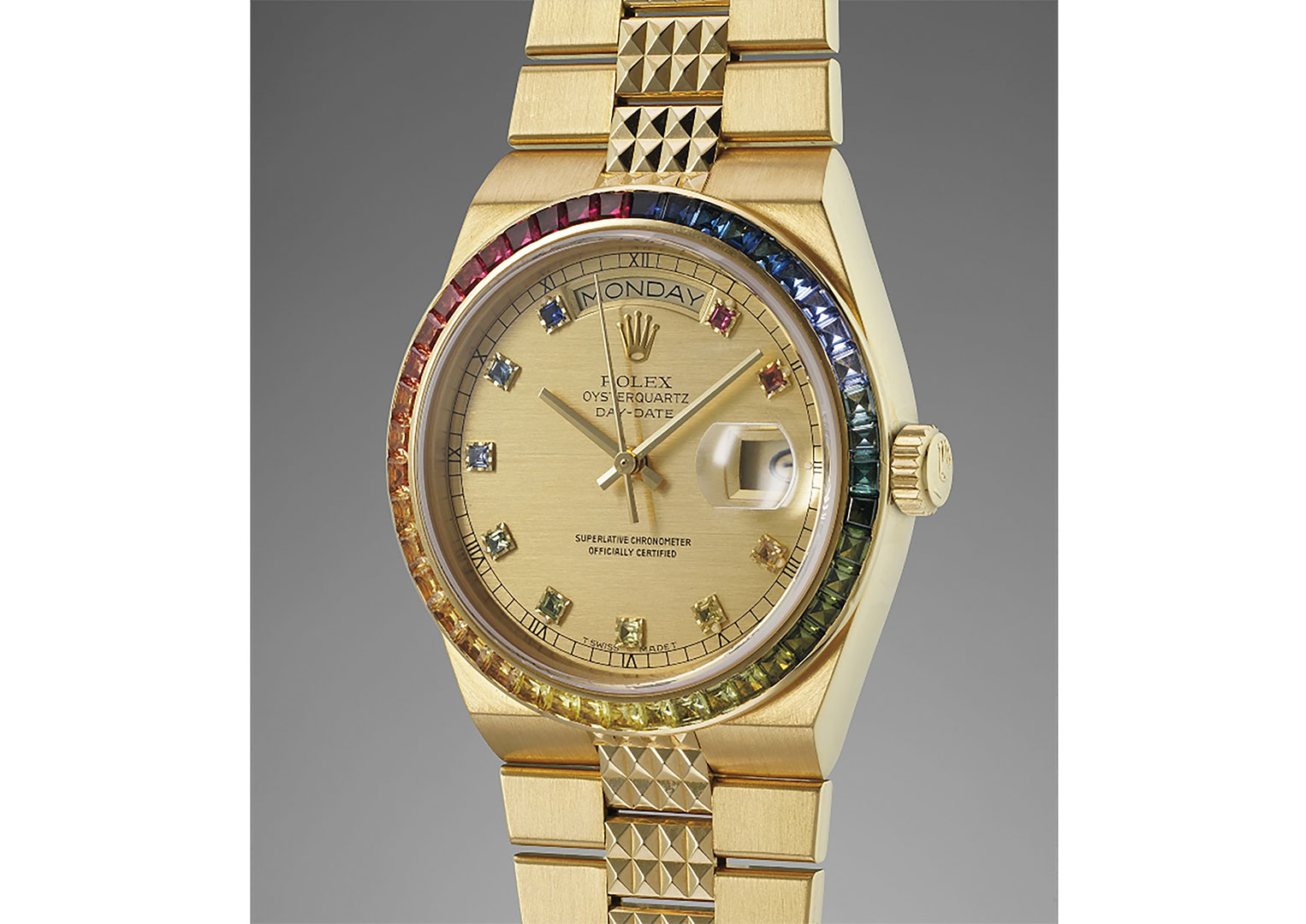 A highly unusual yellow-gold Day-Date Oysterquartz from the late 1980s with rainbow multi-gem bezel. Image courtesy of Phillips